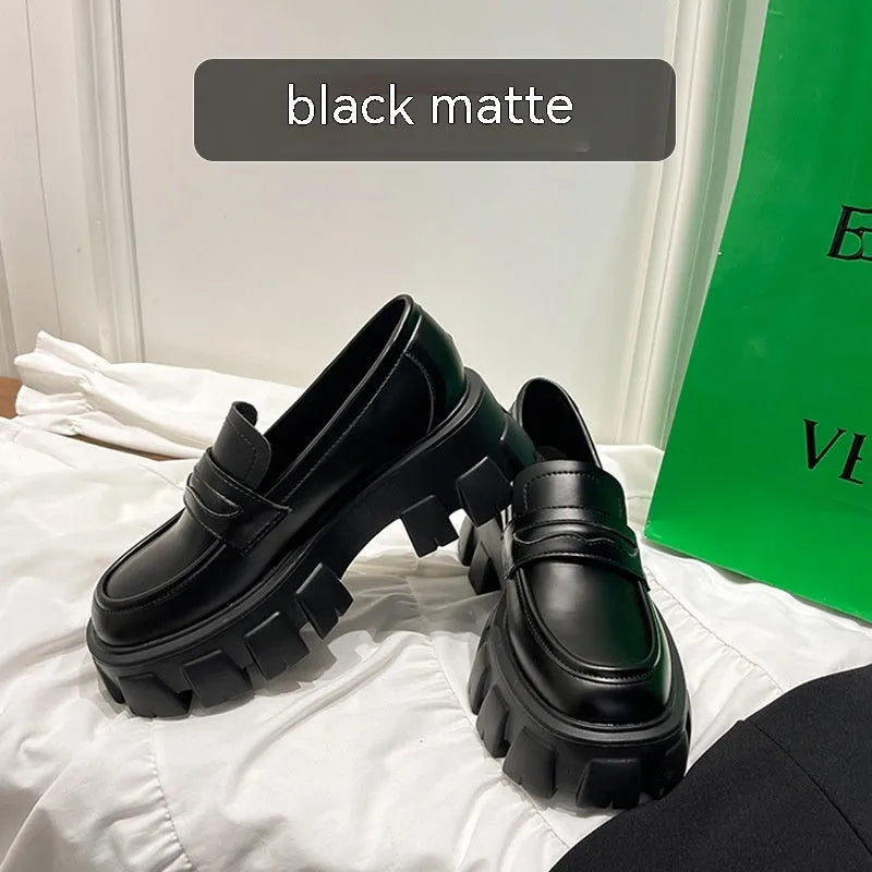 A pair of wide fit leather loafers in a slip-on style with a rubber sole, shown in a choice of finishes.