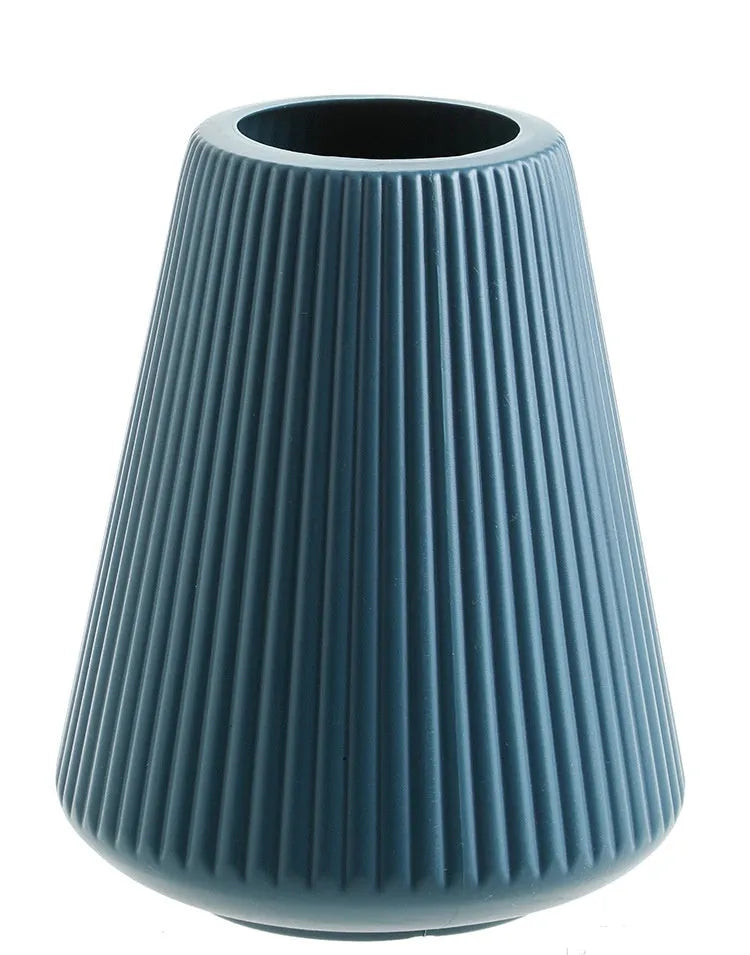 A simple style melamine plastic decorative flower vase in blue, measuring 16cm by 20cm, on a desktop.