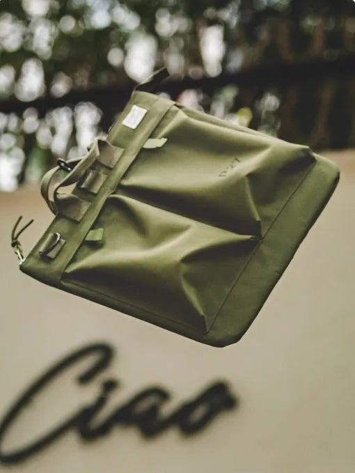 Canvas crossbody shoulder bag in military green with phone pocket and space for 15-inch laptop