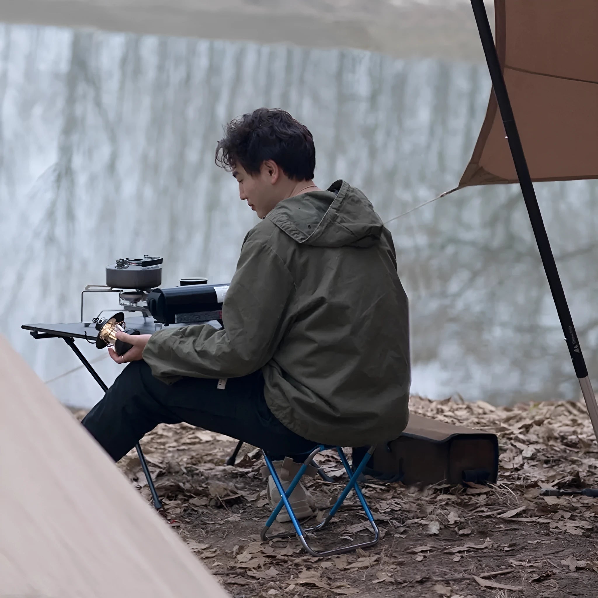 Black aluminium alloy folding stool in folded and unfolded positions