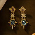 Pair of gold-coloured geometric round stud earrings with retro court style design