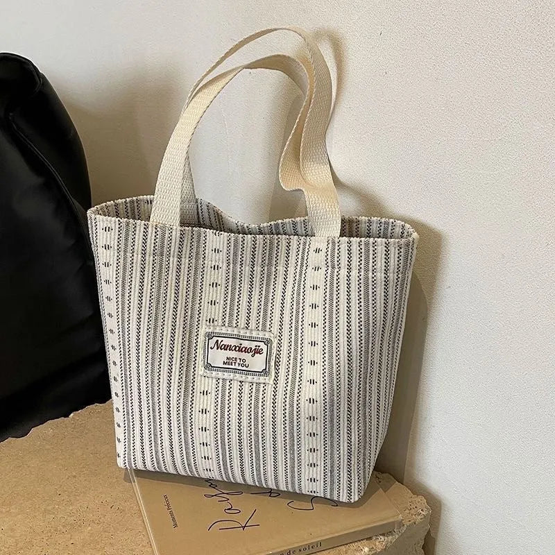Japanese style corduroy handbag in dark brown showing textured fabric and minimalist design.