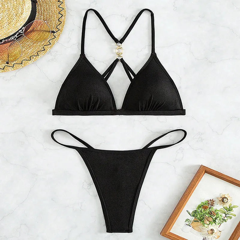 Black women's hollow backless split triangle bikini set with matching top and pants.