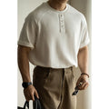 Women's loose grey casual pullover top with raglan sleeves on a hanger.