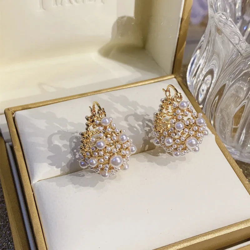 Gold women's flower basket earrings with pearl bead decoration on copper