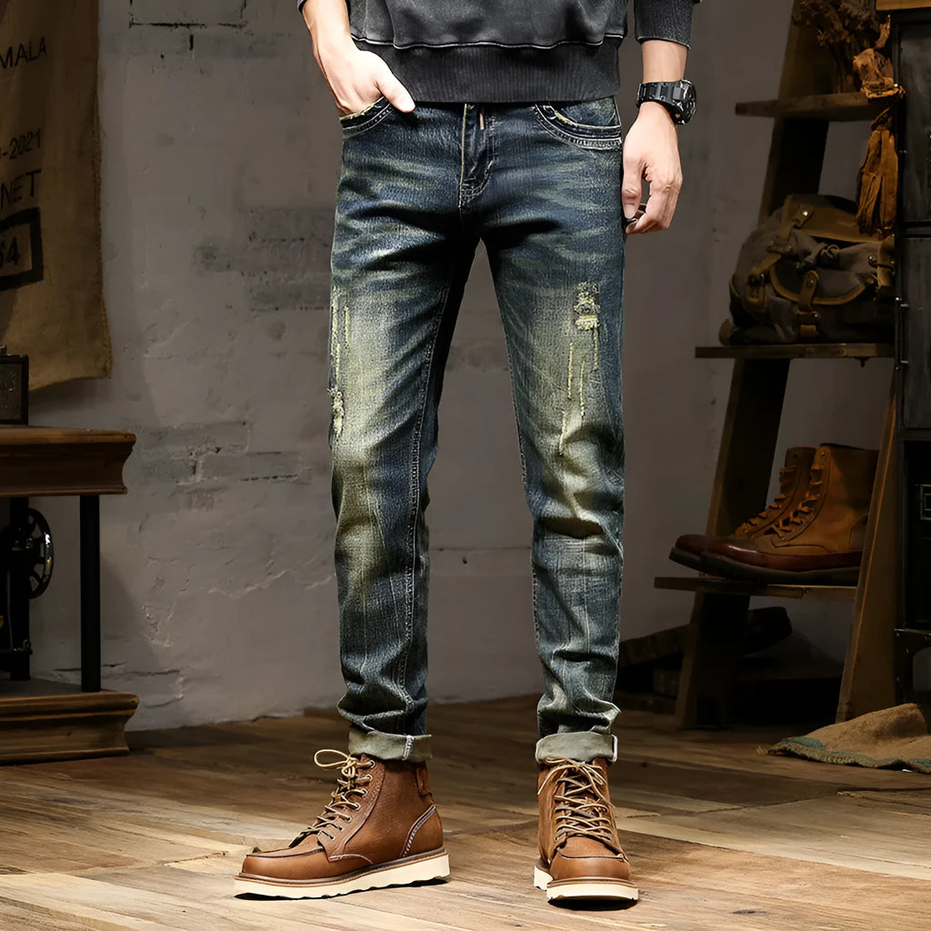 Men's skinny fit stretch denim jeans in a retro colour with a zip fly, laid flat.
