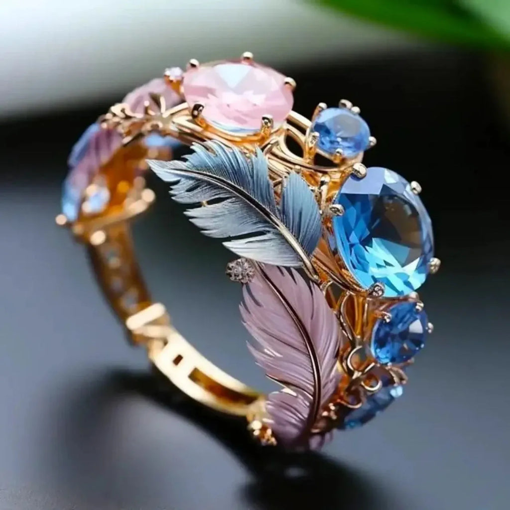 Gold brass ring with embossed feather design and zircon stones in geometric shape