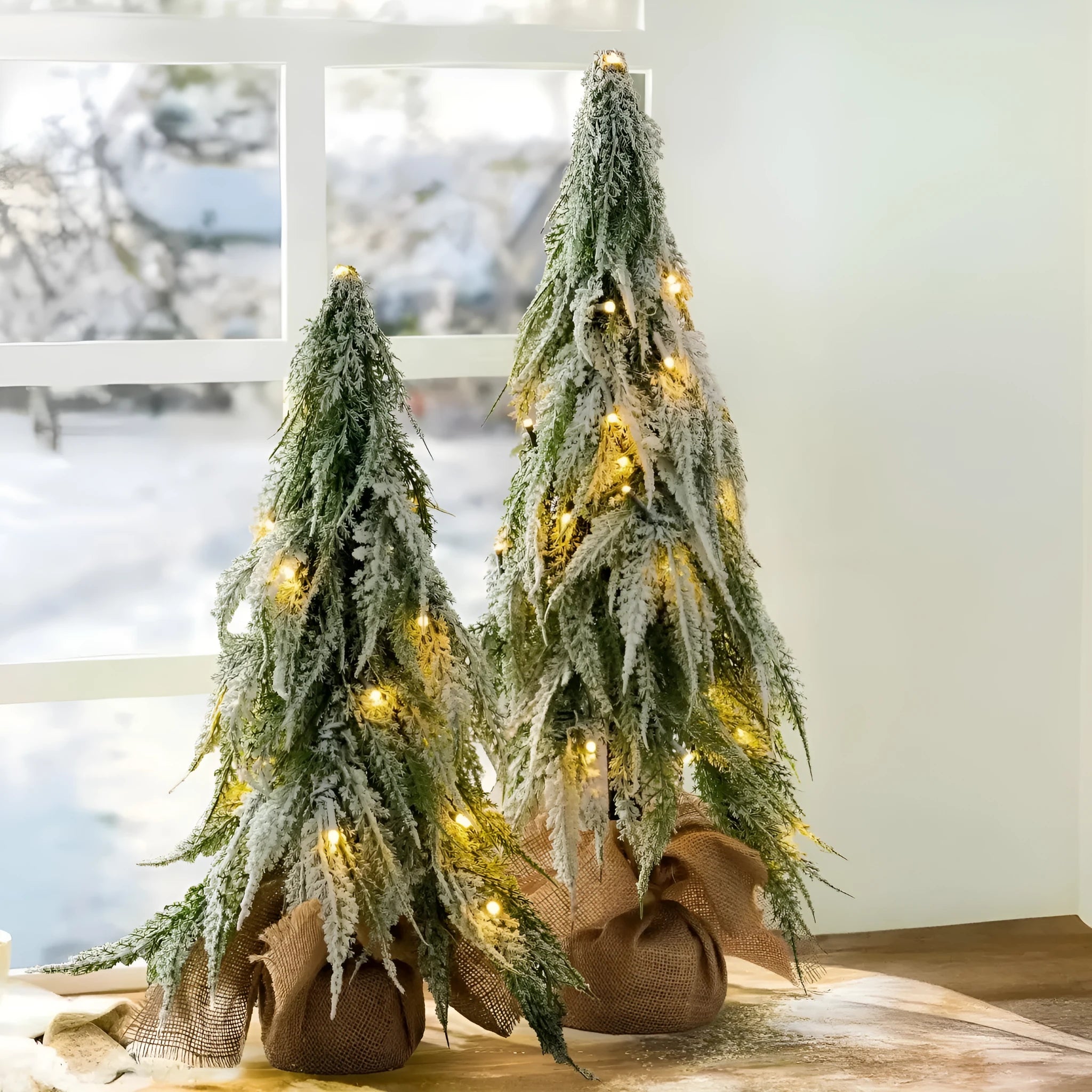 24-inch artificial Christmas tree with white snow finish and built-in LED lights on branches