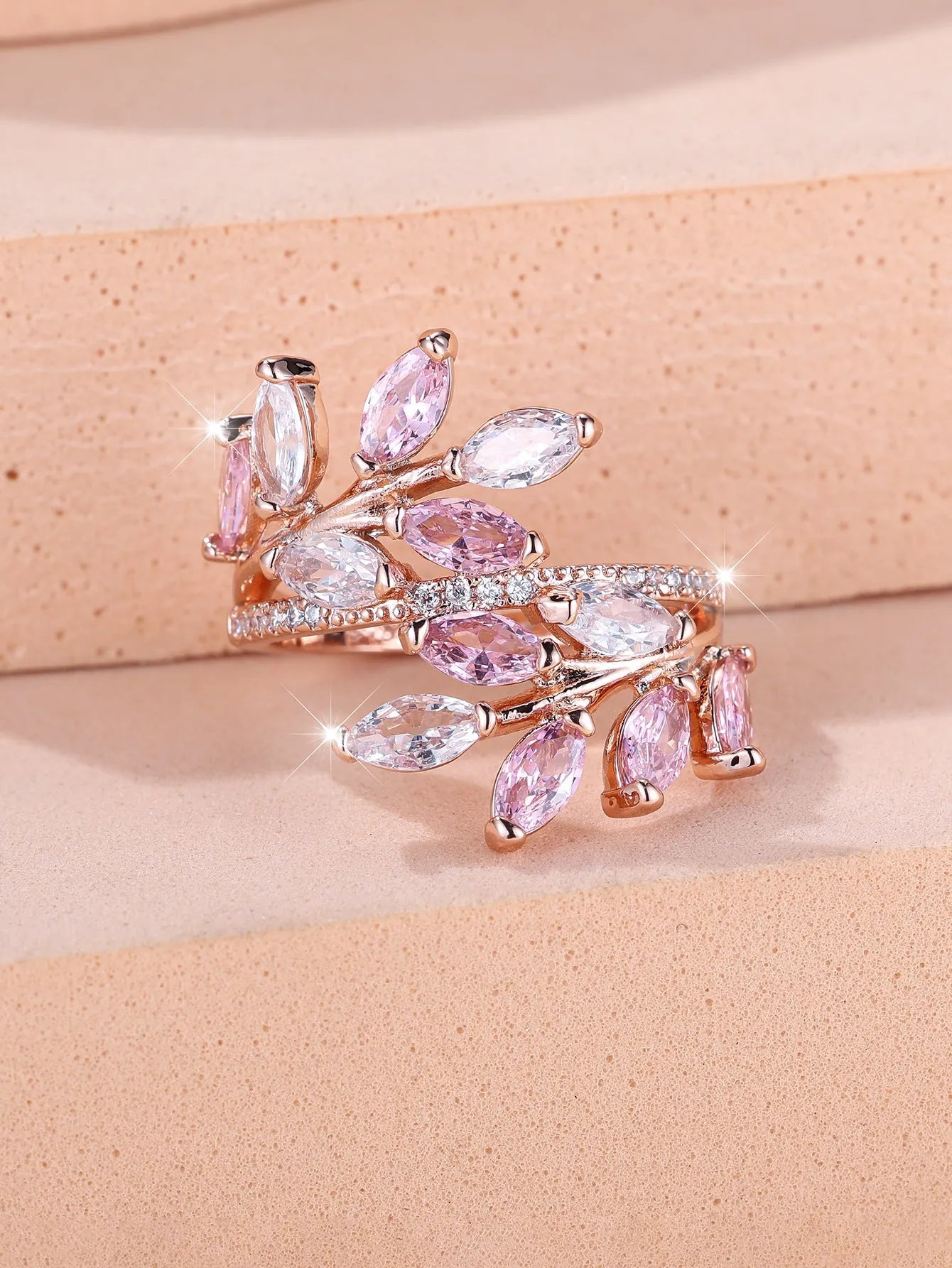 Adjustable horse eye zircon leaf ring in copper on a hand, showing leaf detail and colour options.