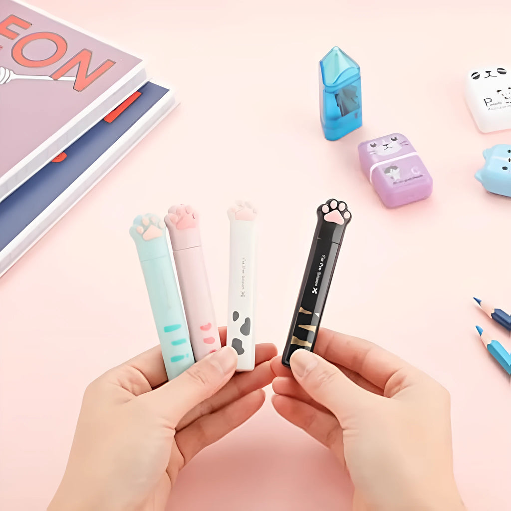 Mini folding craft scissors with cat paw handles in four colours: black, blue, pink, and white.
