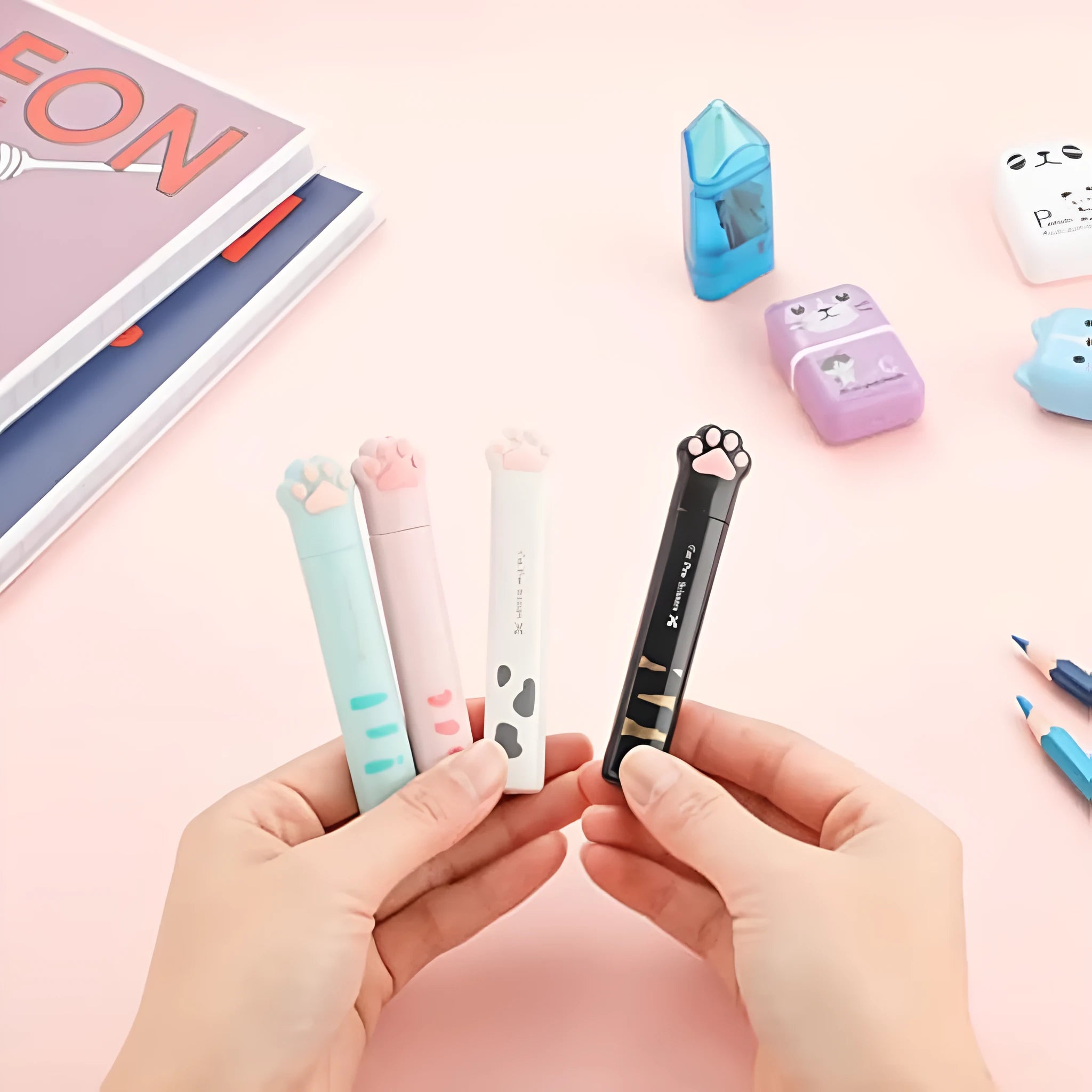 Mini folding craft scissors with cat paw handles in four colours: black, blue, pink, and white.