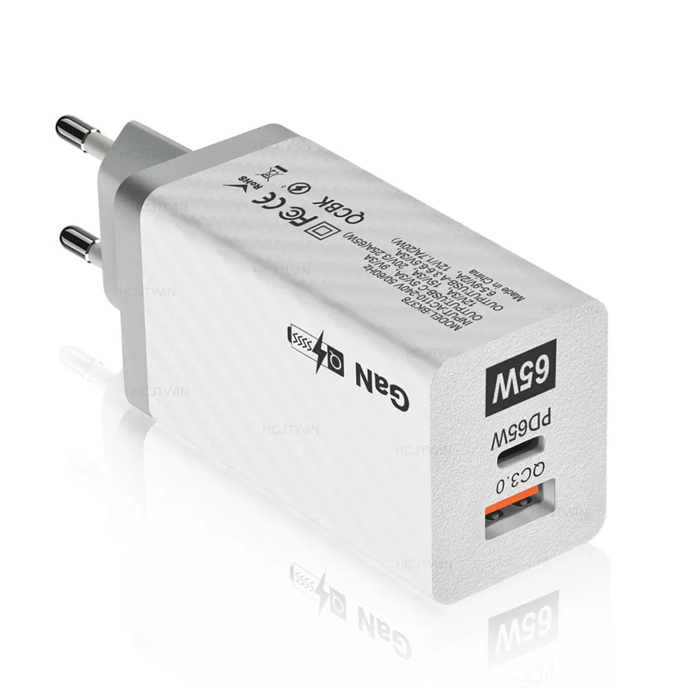 White and black 65W Gallium Nitride USB-PD laptop charger with EU, UK, and US plug options.