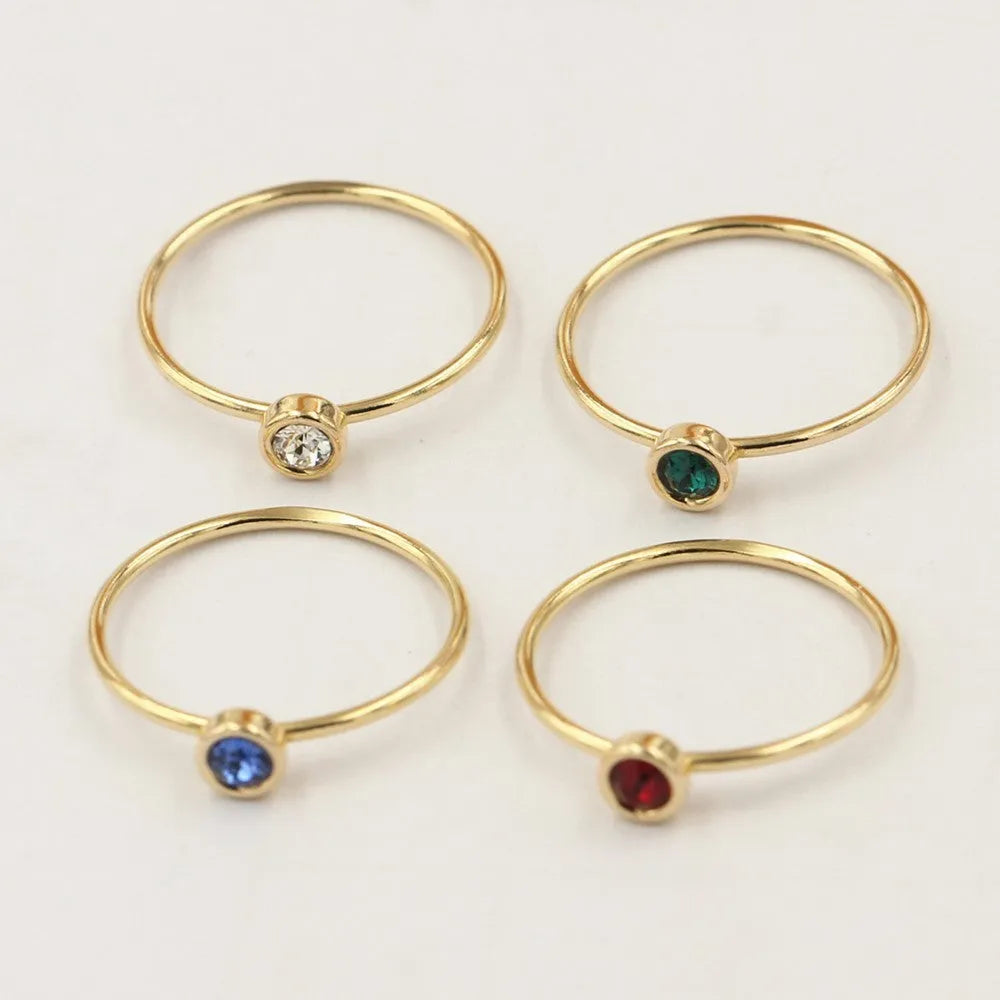 Women's 14K gilded GF zircon knuckle ring shown in green, blue, dark red, and white on a sizing chart.