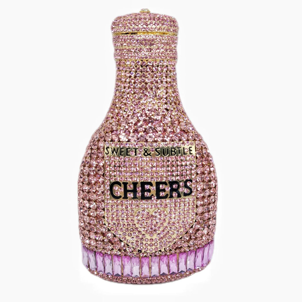 Gold rhinestone champagne bottle shaped evening clutch bag with wrist strap on a dark background.