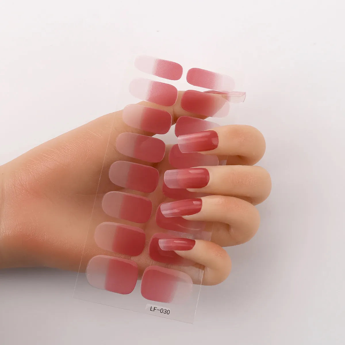 Set of 16 solid colour nail art stickers showing floral, geometric, and pattern designs for manicure application