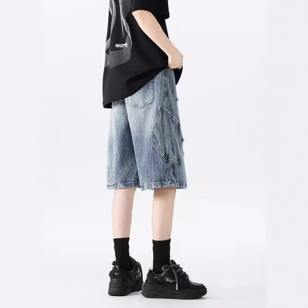 Washed denim shorts with ripped detailing in loose retro fit, black and blue colour options