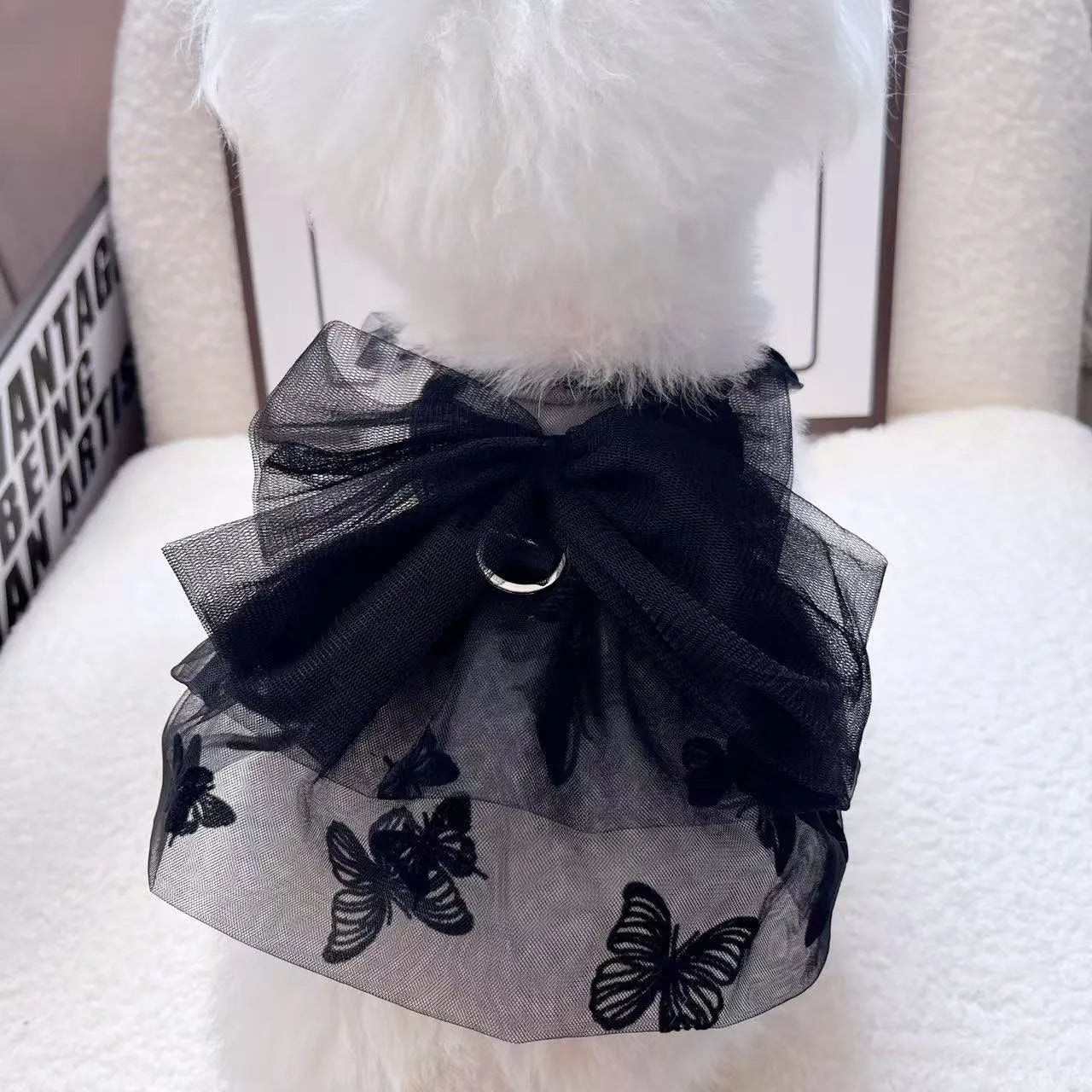 Black polyester tulle princess skirt costume for a small dog or cat on a mannequin, showing the gauzy fabric.