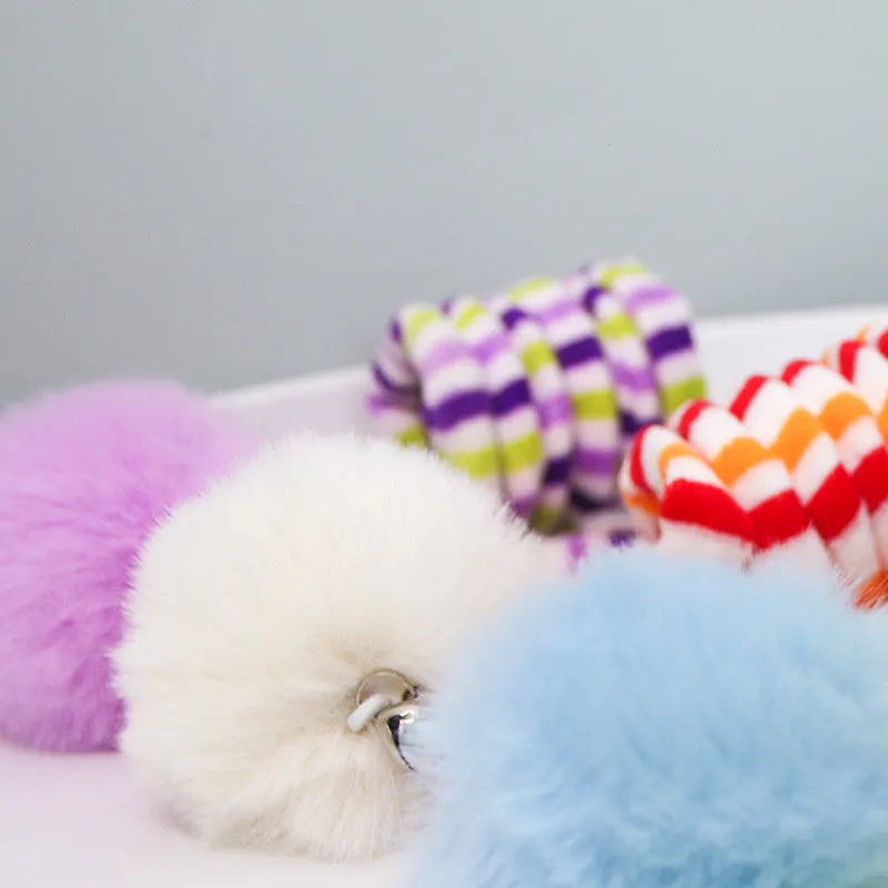 Cat toy with colourful inflatable bell ball on flexible wand and suction cup for door mounting