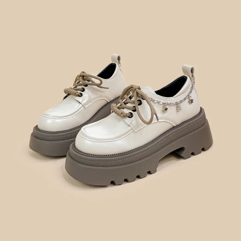 White platform Mary Jane shoes with chunky heel and round toe, front lace-up design