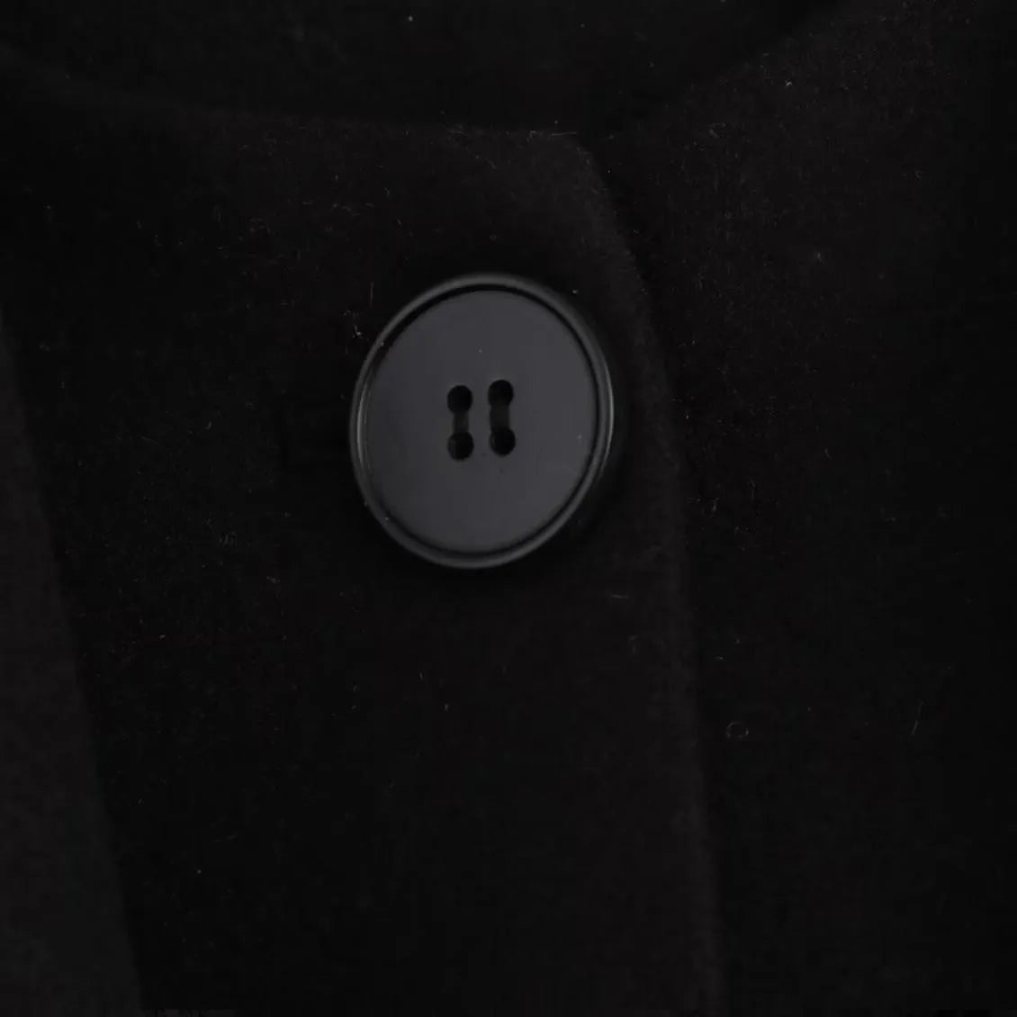Women's long black polyester overcoat with artificial fur collar, shown at full length.