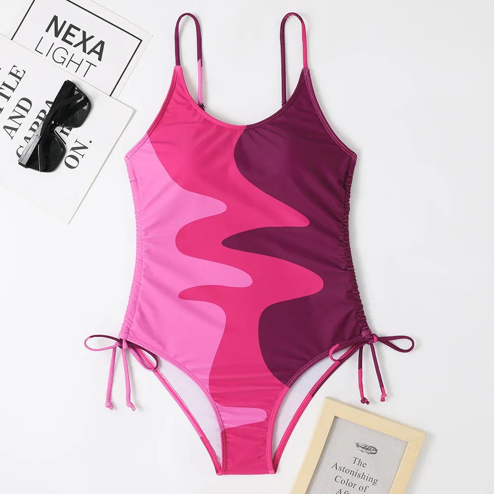 Women's sleeveless one-piece swimsuit in a striped print, showing backless design and available in multiple colours.