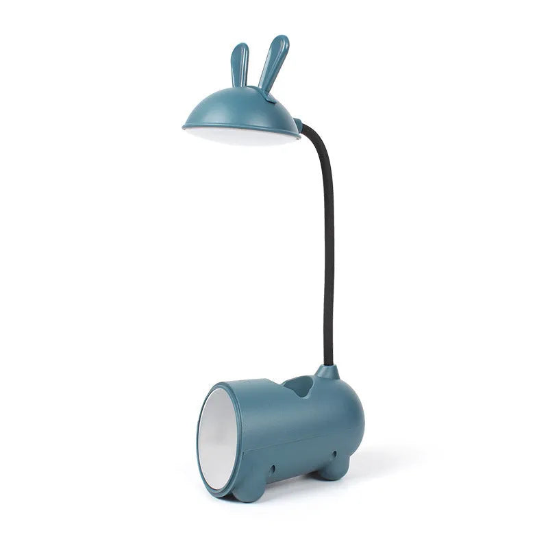 Green cartoon-themed USB table lamp with pen container base on desk