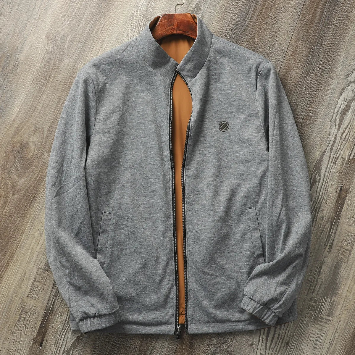 Men's simple stand collar casual jacket in polyester blend fabric, shown on a hanger.