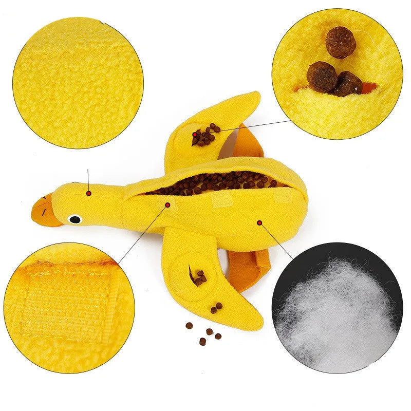 Yellow plush duck dog toy with a sound module and treat-dispensing openings.