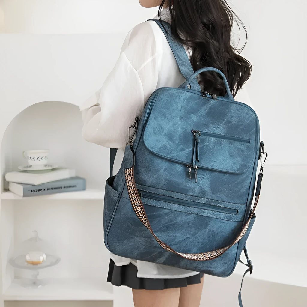Retro college student backpack in PU leather with curved shoulder straps showing stitching detail