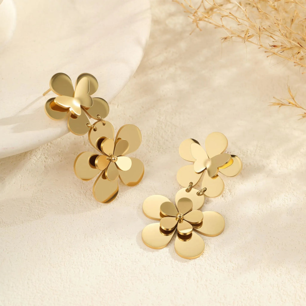 Women's stainless steel earrings with 18K gold electroplated finish featuring floral butterfly and geometric zodiac design