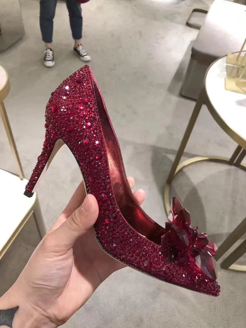 Gold women's pointed toe stiletto high heels with rhinestone and sequin decoration on a shallow-mouth, low-top upper.