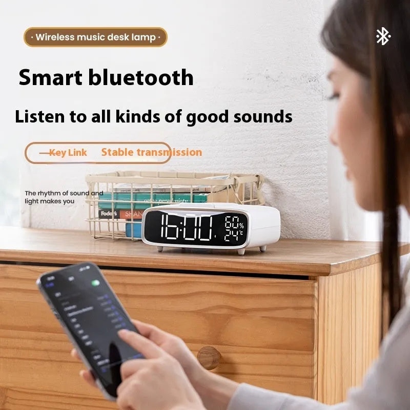 White wireless charger Bluetooth speaker with night light function on wooden surface