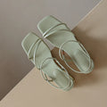 Women's flat green microfiber Roman sandals with square open toe on a white background.