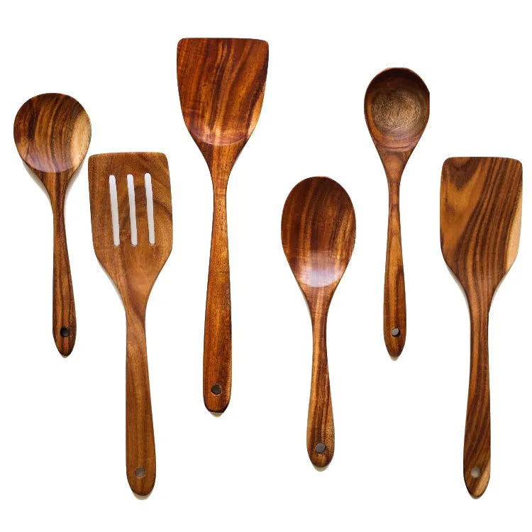 7-piece beechwood cooking utensil set including wooden spoon, spatula, ladle, and pasta fork on kitchen counter