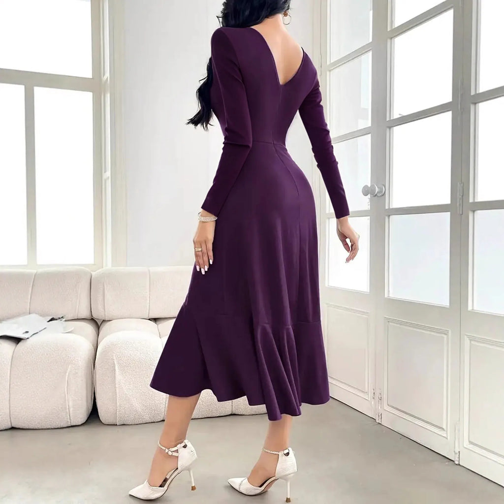 Purple women's long sleeve pullover dress with round neck and ruffle detail on a hanger.