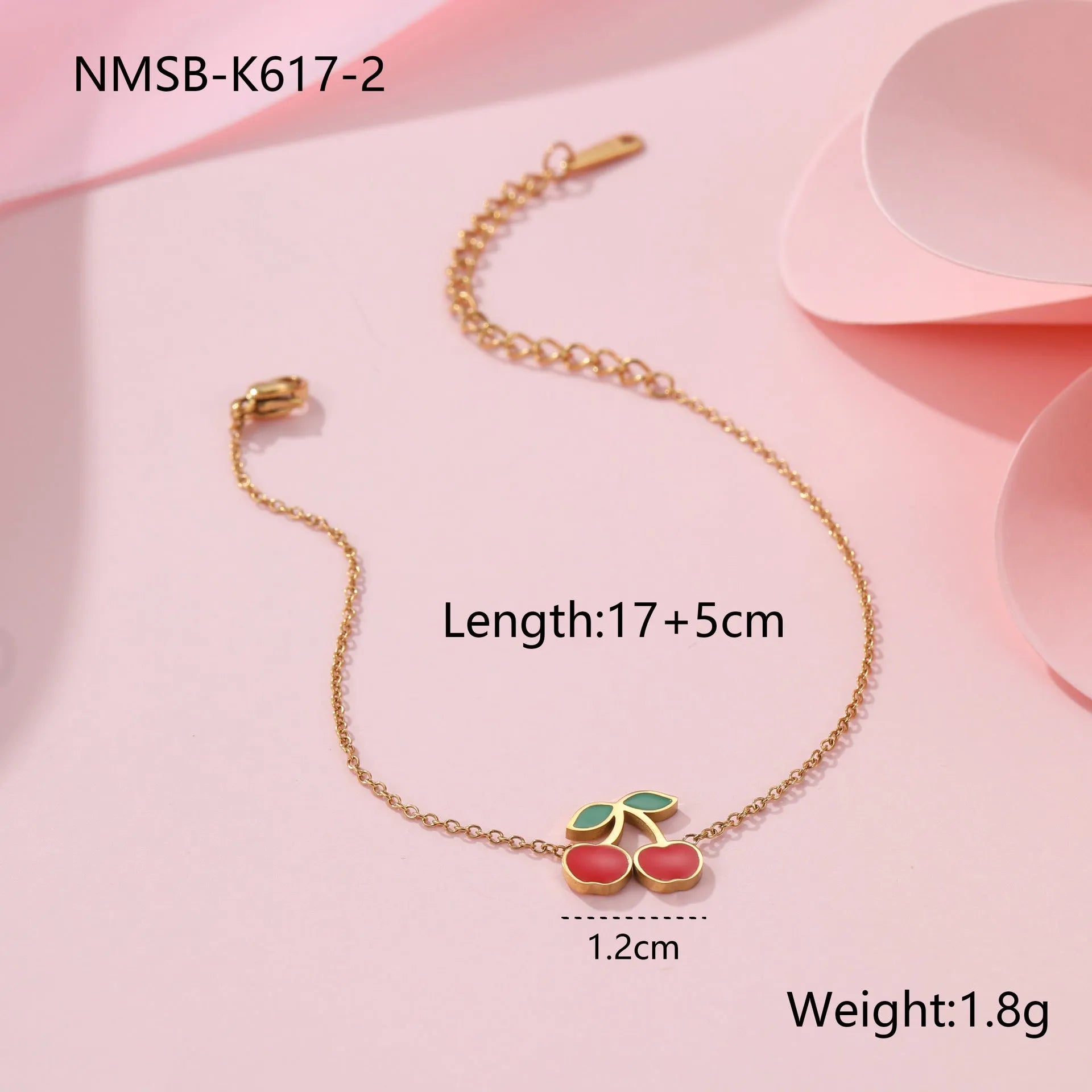 Cherry jewellery set showing necklace, bracelet, earrings, and ring with stainless steel construction and 18K gold electroplated finish
