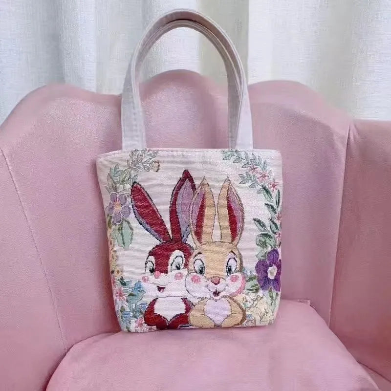 Handheld canvas bag with gold wire embroidery, shown in one of seven colour designs.
