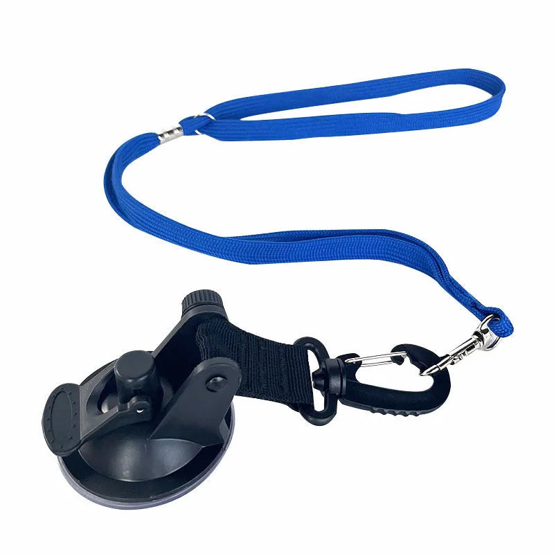 Pet bathing restraint tool with large suction cups, handcuffs, and a connecting rope on a bathroom tile background.