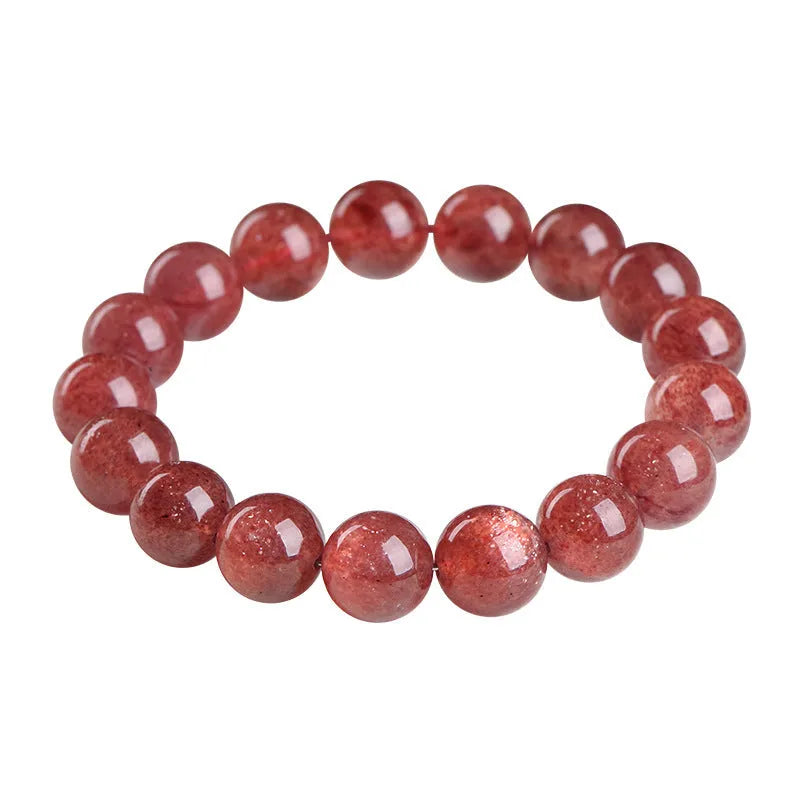 Natural strawberry quartz bracelet with geometric red crystal beads on a white background