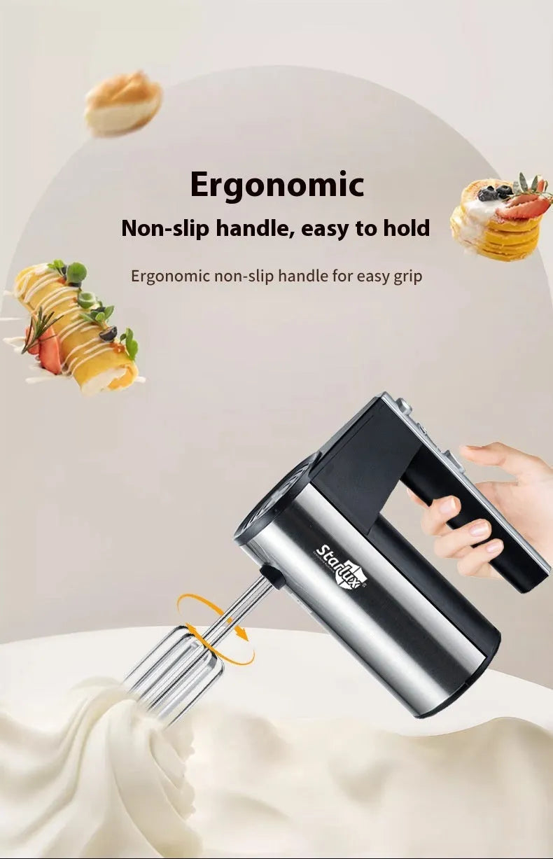 White handheld electric mixer with a stainless steel whisk attachment on a kitchen counter