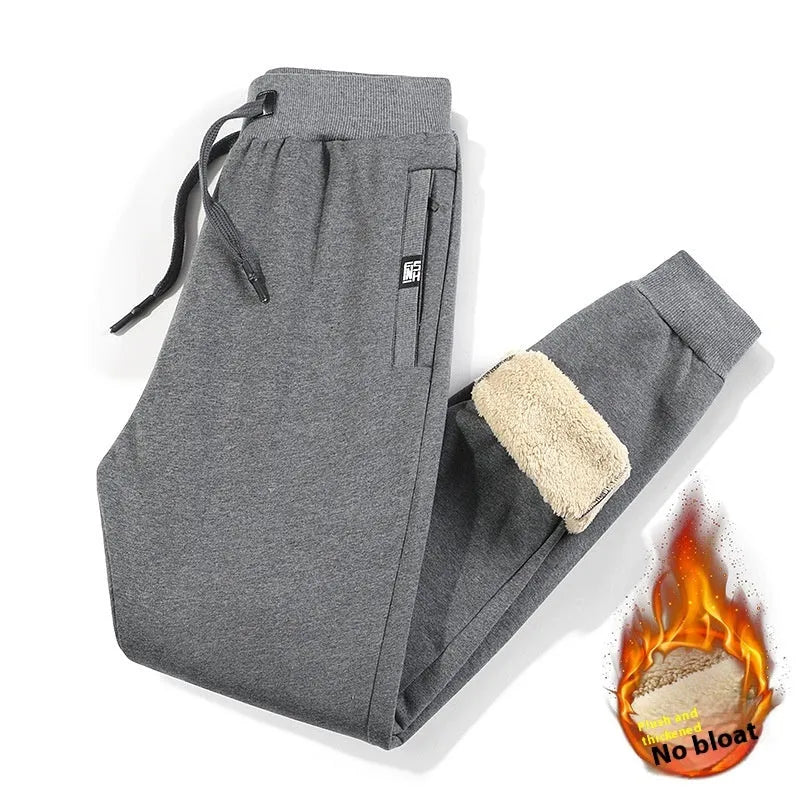 Men's grey fleece-lined cotton track pants with elastic waistband shown on hanger