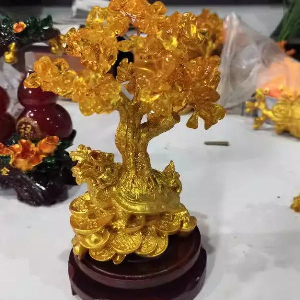 Citrine-coloured Chinese style resin turtle money tree ornament on display.