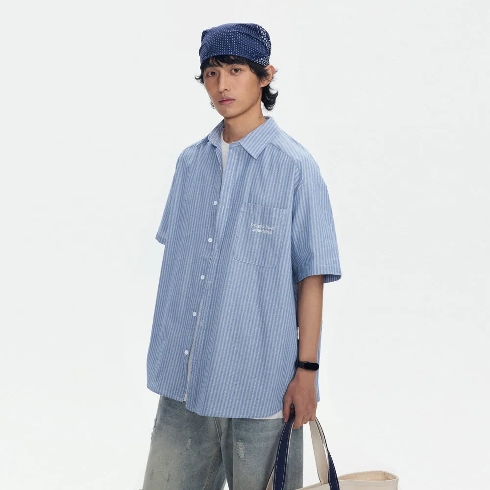Blue and white striped loose-fitting short-sleeve cardigan shirt on a hanger