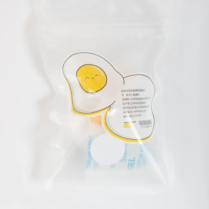 Catnip ball toy in fried egg and poached egg shapes with adhesive backing for wall mounting