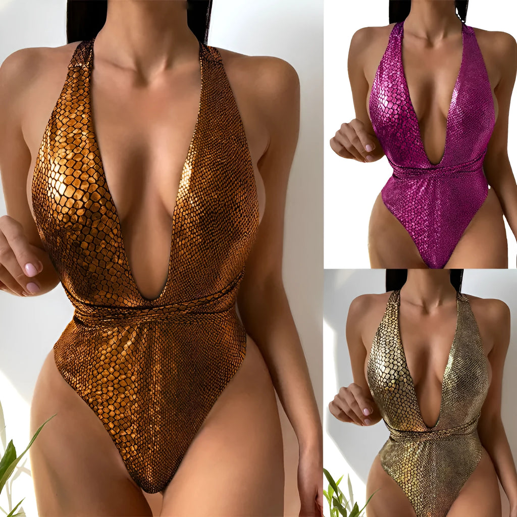 A woman wearing a gold sequinned one-piece swimsuit on the beach.