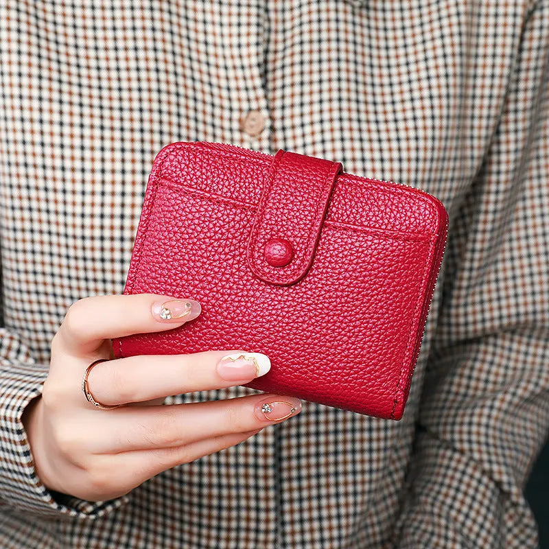 Women's lychee pattern short wallet in beige, pink, black, or red colours with decorative sewing thread detail.