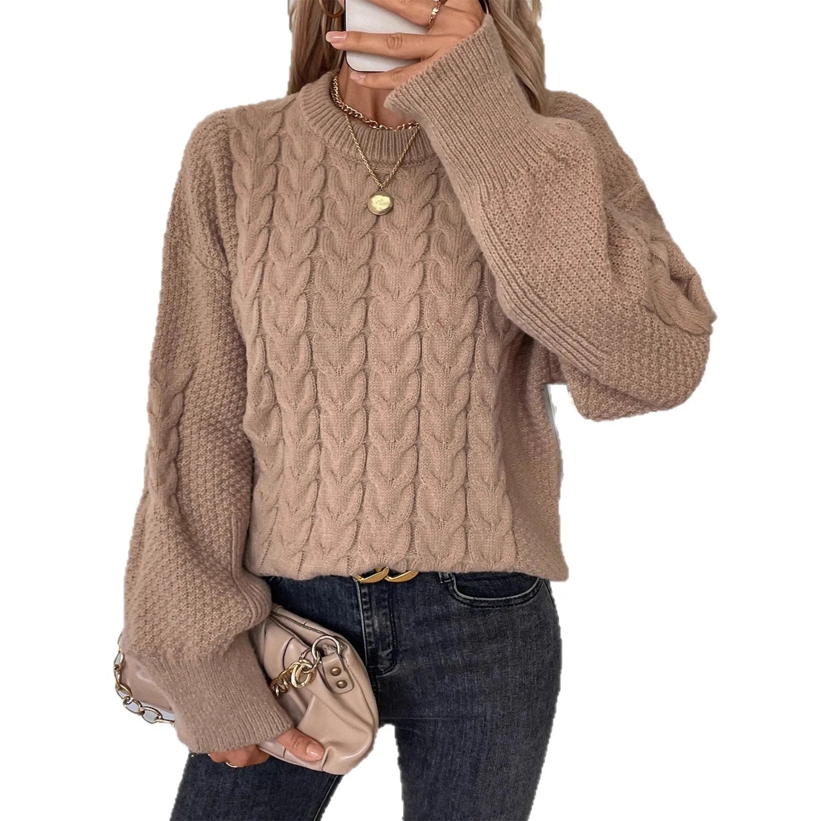 Women's loose beige casual sweater with round neck and twist detail on a hanger.