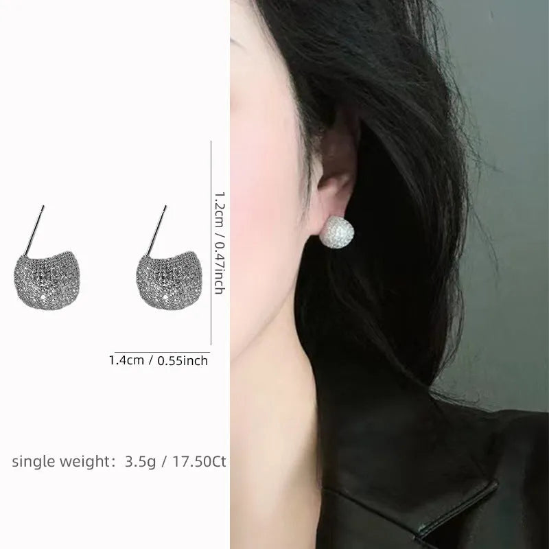 Gold and white geometric drop earrings with sparkling diamond-cut bean spheres.