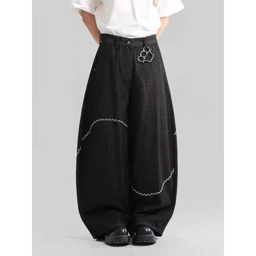 Black straight-leg denim trousers with a mid-waist and zip fly on a mannequin.