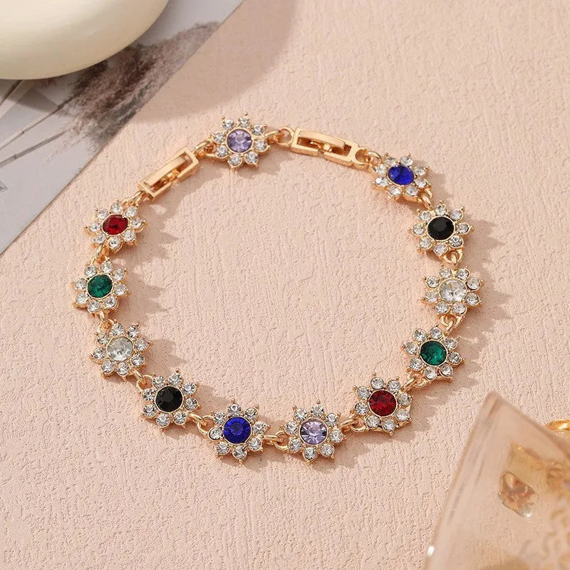 Gold and silver electroplated flower bracelet with coloured gemstone accents on zinc alloy